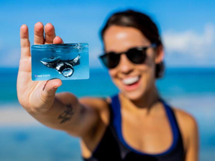 woman holding a certification card
